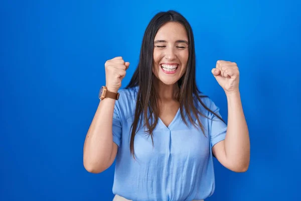 Young Brunette Woman Standing Blue Background Excited Success Arms Raised —  Fotos de Stock