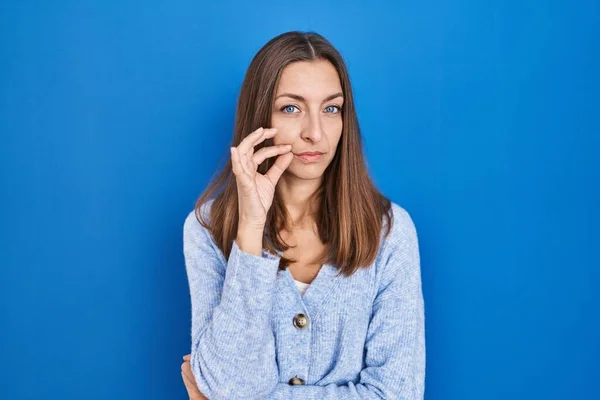 Young Woman Standing Blue Background Mouth Lips Shut Zip Fingers — Stock Photo, Image