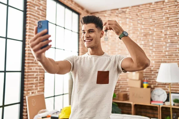 Young Hispanic Man Having Video Call Holding Key House New — Foto Stock