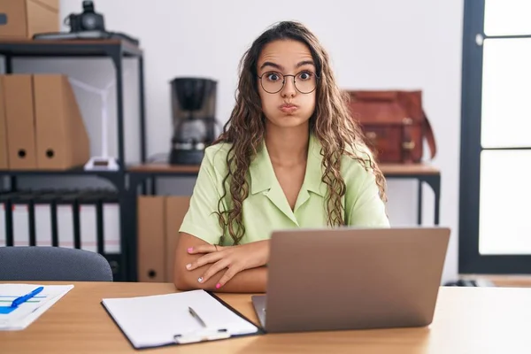 Young Hispanic Woman Working Office Wearing Glasses Puffing Cheeks Funny — Stockfoto