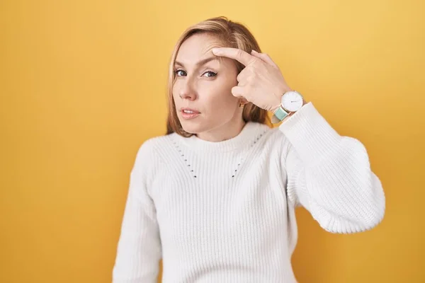 Young Caucasian Woman Wearing White Sweater Yellow Background Pointing Unhappy — Stock Photo, Image