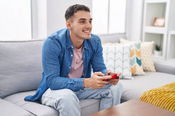 Young Hispanic Man Playing Video Game Sitting Sofa Home — Fotografia de Stock