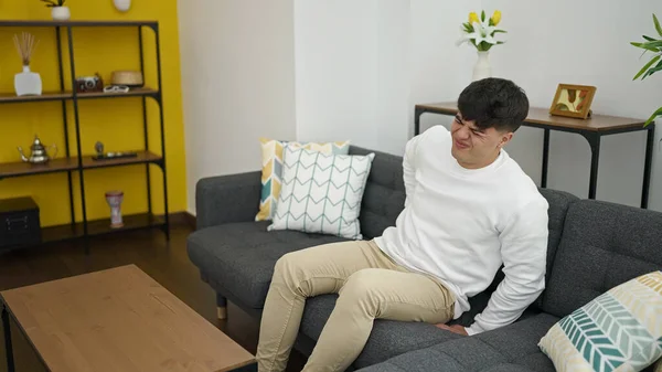 Young Hispanic Man Suffering Backache Sitting Sofa Home — Foto Stock