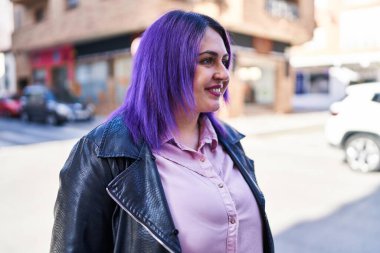 Young beautiful plus size woman smiling confident looking to the side at street