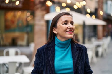 Middle age woman business executive smiling confident standing at street