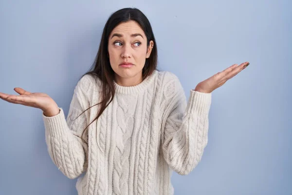 Young Brunette Woman Standing Blue Background Clueless Confused Expression Arms — Stock Photo, Image