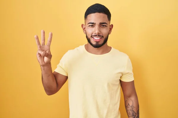 Young Hispanic Man Standing Yellow Background Showing Pointing Fingers Number — Stockfoto