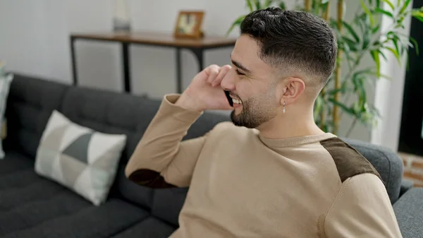 Young Arab Man Talking Smartphone Sitting Sofa Home — Stockfoto