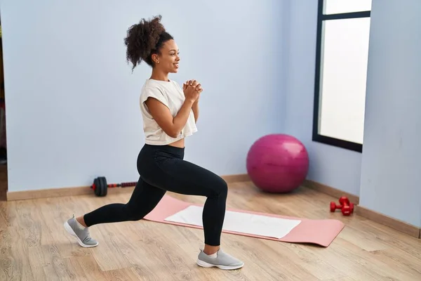 stock image Young african american woman smiling confident stretching at sport center