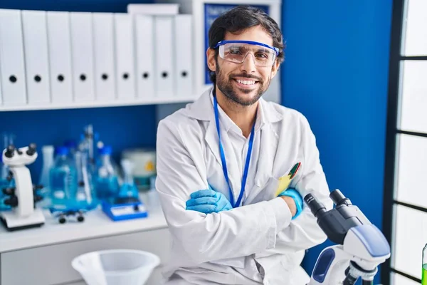 Young Hispanic Man Scientist Smiling Confident Arms Crossed Gesture Laboratory — Stock Photo, Image