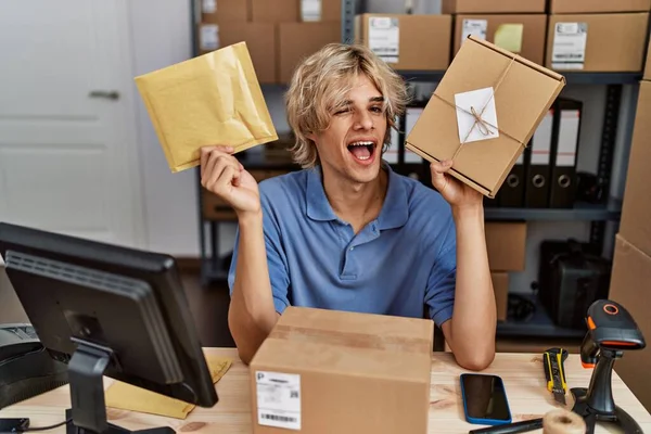 Young Man Working Small Business Ecommerce Holding Packages Winking Looking — Stock Photo, Image