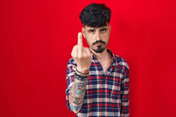 Young Hispanic Man Beard Standing Red Background Showing Middle Finger — 图库照片