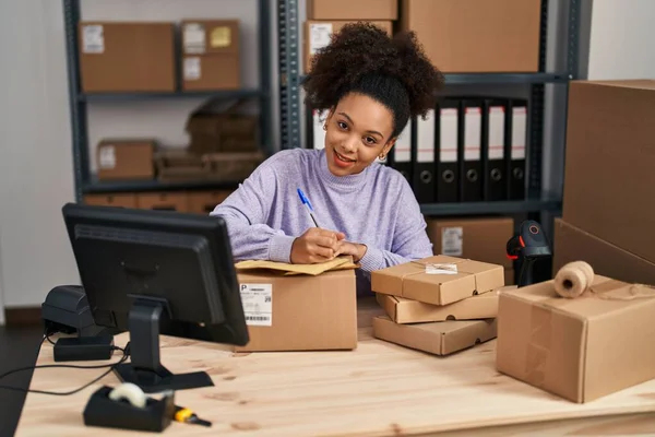 Young African American Woman Smiling Confident Writing Package Office — Stock Photo, Image