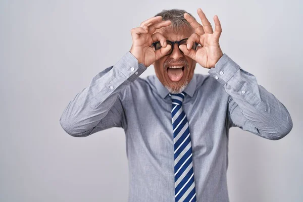 Hispanic Business Man Grey Hair Wearing Glasses Doing Gesture Binoculars — Stock Photo, Image