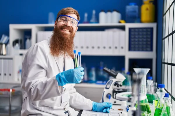 Young Redhead Man Scientist Holding Test Tubes Writing Report Working — Stockfoto