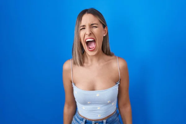 Young Woman Standing Blue Background Angry Mad Screaming Frustrated Furious — Stockfoto