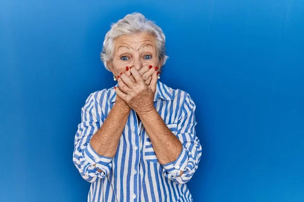 Senior Woman Grey Hair Standing Blue Background Shocked Covering Mouth — Stock Photo, Image