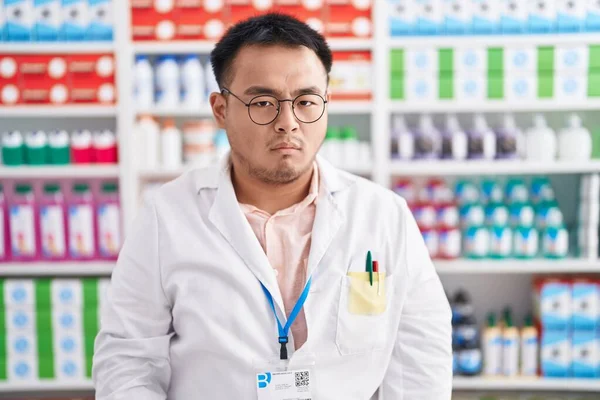 Chinese Young Man Working Pharmacy Drugstore Skeptic Nervous Frowning Upset — Stock Photo, Image