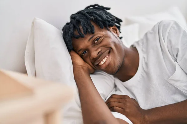 Stock image African american man smiling confident lying on bed at bedroom