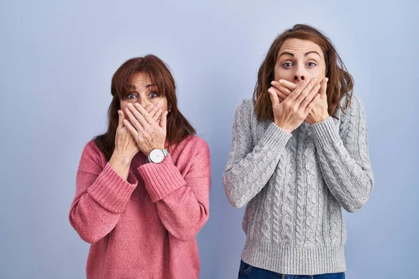 Mother Daughter Standing Blue Background Shocked Covering Mouth Hands Mistake — Stock Photo, Image