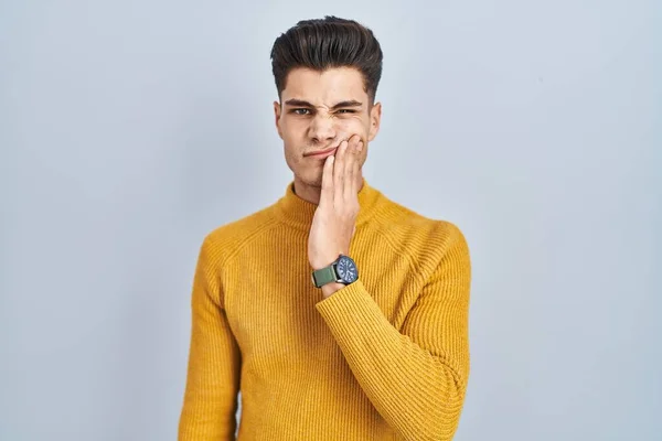 Young Hispanic Man Standing Blue Background Touching Mouth Hand Painful — Stockfoto