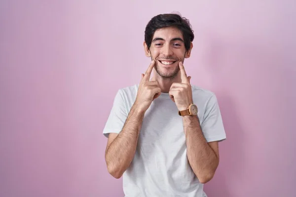 Young Hispanic Man Standing Pink Background Smiling Open Mouth Fingers — стоковое фото