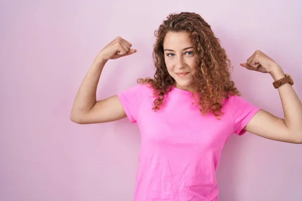 Young Caucasian Woman Standing Pink Background Showing Arms Muscles Smiling — Stock fotografie