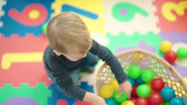 愛らしいブロンド幼児投げボールスタンディングに幼稚園 — ストック動画