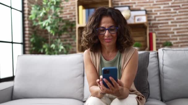 Middle Age Hispanic Woman Using Smartphone — Video