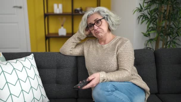 Middle Age Woman Grey Hair Watching Sitting Sofa Boring Expression — Stock video