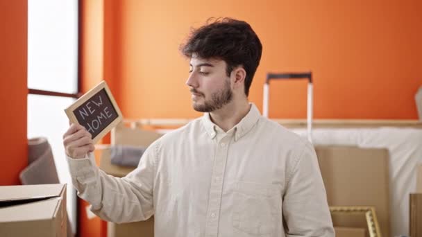 Young Hispanic Man Smiling Confident Holding Blackboard New Home — Video Stock