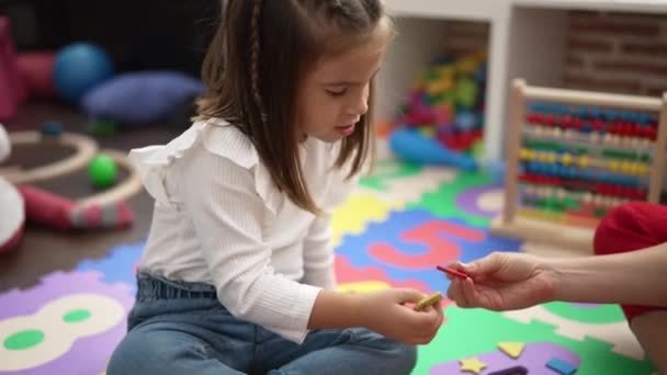 Adorable Hispanic Girl Playing Maths Puzzle Game Sitting Floor Kindergarten — Wideo stockowe