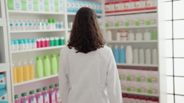 Young african american woman pharmacist smiling confident standing with arms crossed gesture at pharmacy