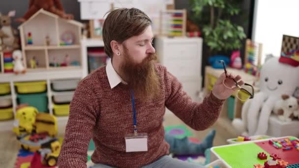 Young Redhead Man Preschool Teacher Stressed Sitting Chair Kindergarten — Video Stock