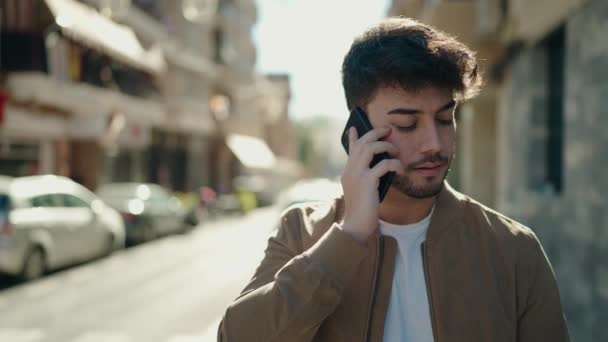 Young Hispanic Man Talking Smartphone Street — Vídeo de Stock