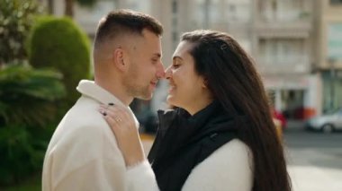 Young couple smiling confident hugging each other standing at park