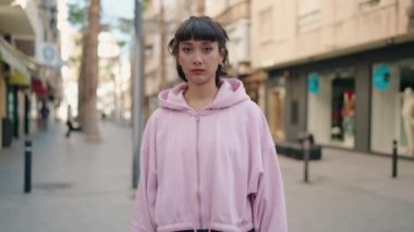 Sokakta kendine gülen genç İspanyol kadın.