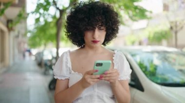 Young middle east woman using smartphone at street