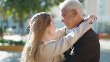 Middle age couple couple smiling confident dancing at park