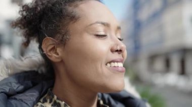 African american woman smiling confident breathing at street