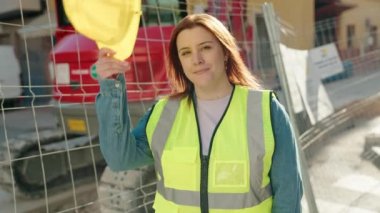 Young beautiful plus size woman architect smiling confident standing at street