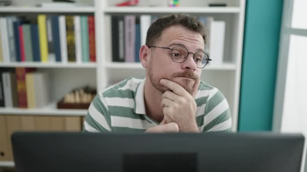 Young Caucasian Man Using Computer Thinking Library University — Stock video