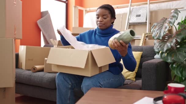 African American Woman Packing Cardboard Box New Home — Stockvideo