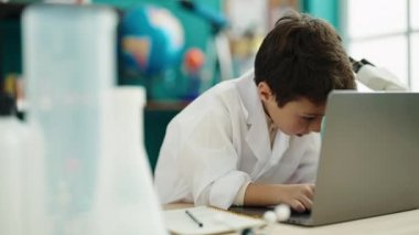 Sevimli İspanyol öğrenci laboratuvar sınıfında dizüstü bilgisayar kullanıyor.