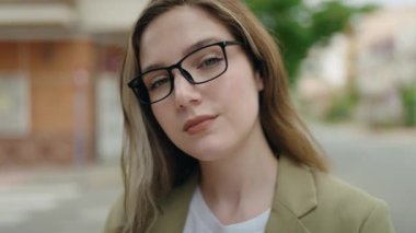 Young woman business worker smiling confident at street