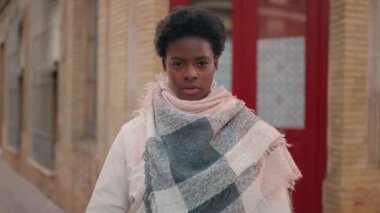 Young african american woman photographer using professional camera at street