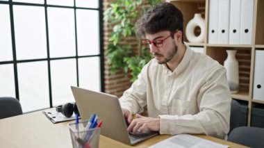 Young hispanic man business worker having video call at office