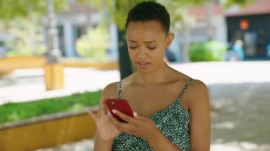 African american woman smiling confident having video call at park