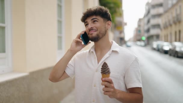 Young Arab Man Talking Smartphone Eating Ice Cream Street — Stock video