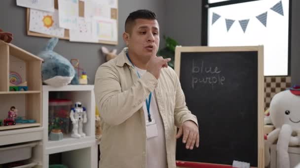 Young Hispanic Man Preschool Teacher Asking Silence Kindergarten — Stock Video